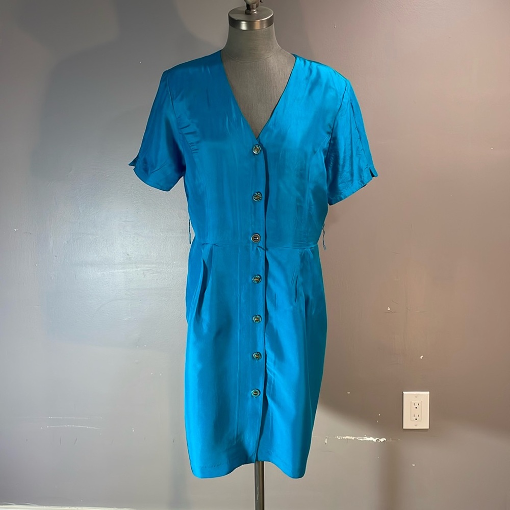 100% unlined silk button up dress in gorgeous teal blue size 14.  Super cute on!